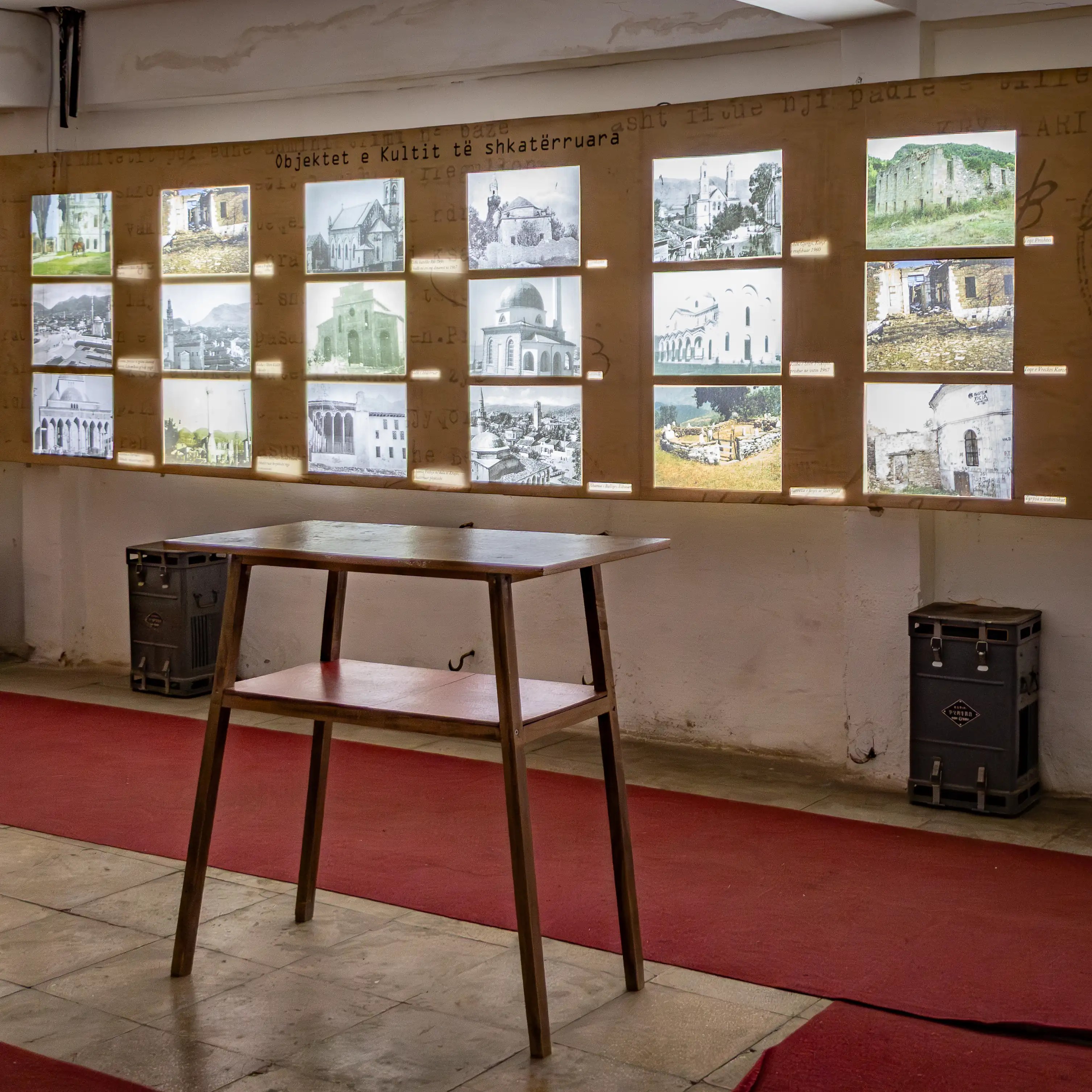 Exhibit displaying photographs of damaged religious buildings during Albania's communist era at Bunk'Art 1.