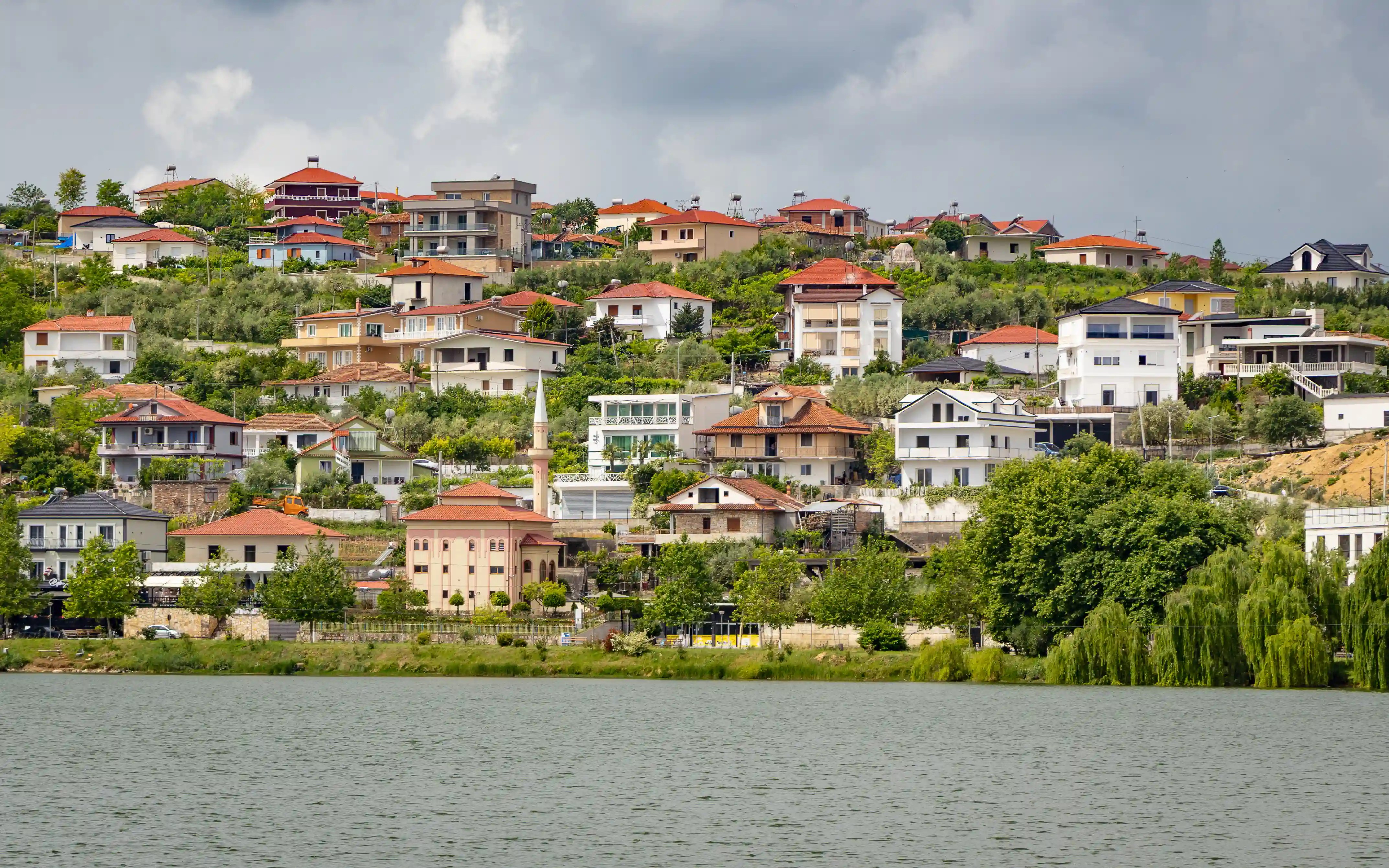 Belsh's lakeside neighborhoods and a mosque are visible across Belshi Lake.