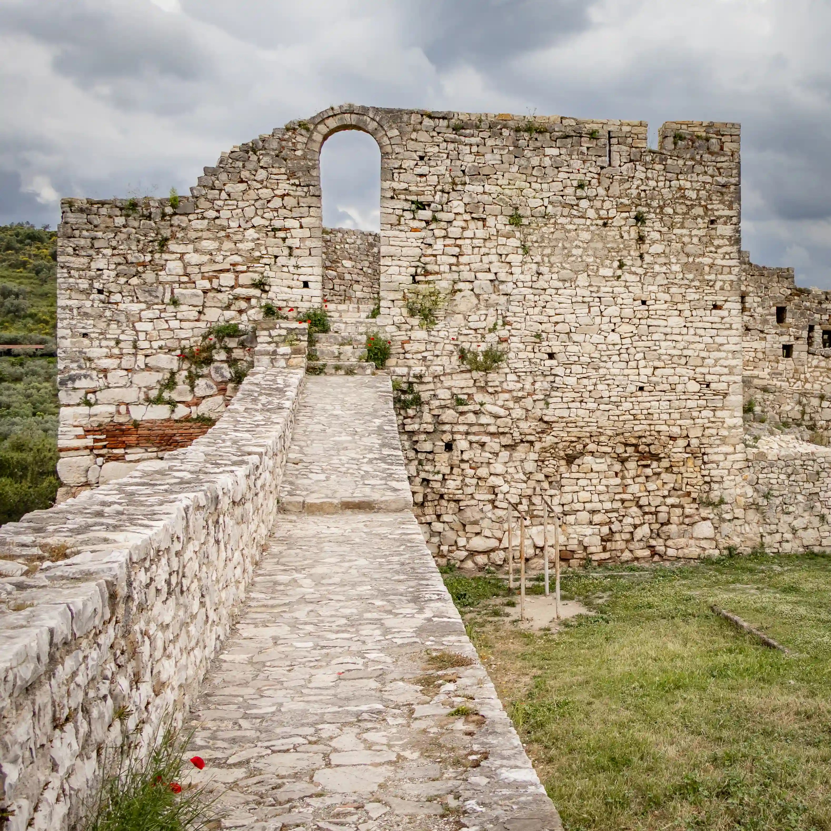 Stone walkway leading through the walls of Berat Castle.