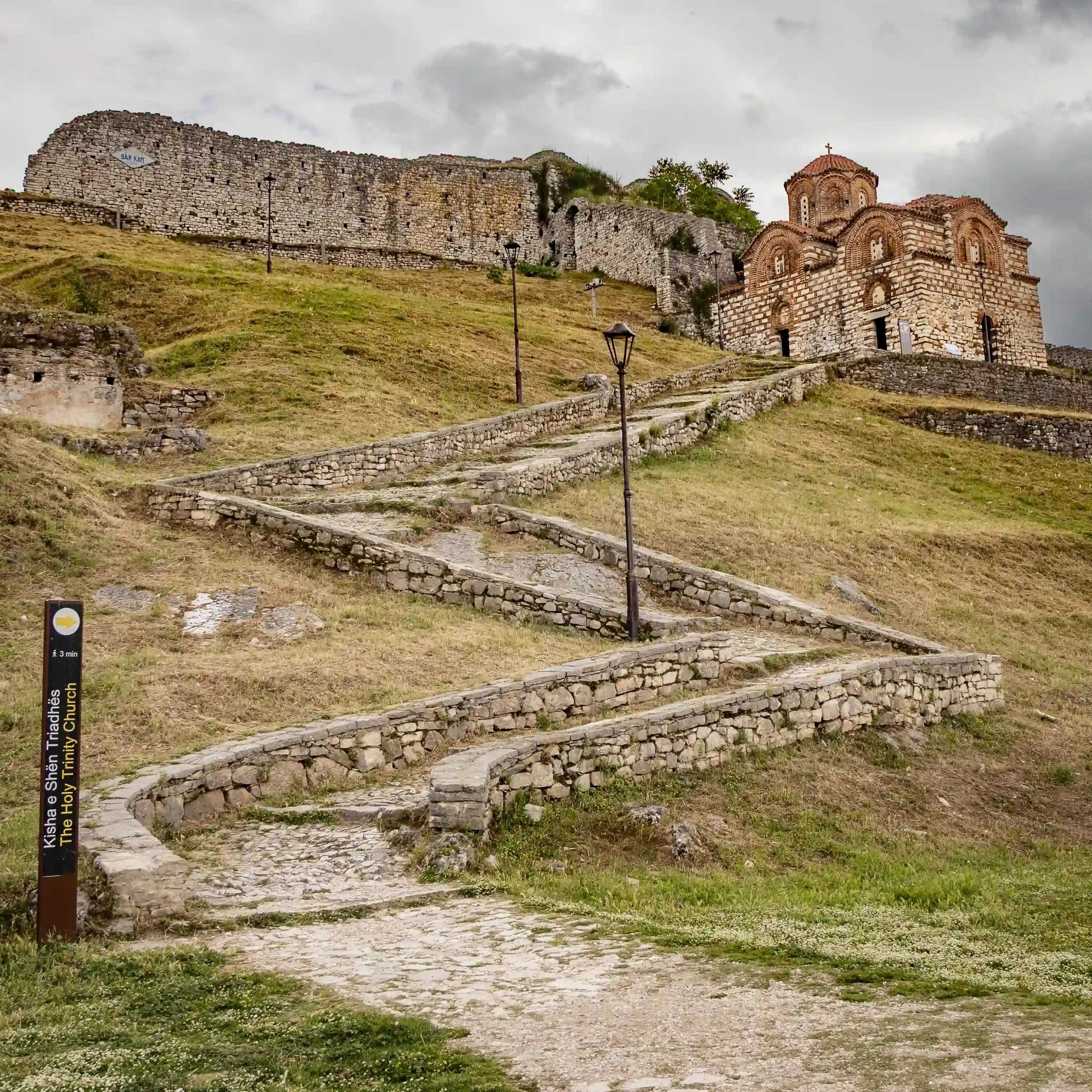 Stone pathway leading uphill to the Holy Trinity Church inside Berat Castle.
