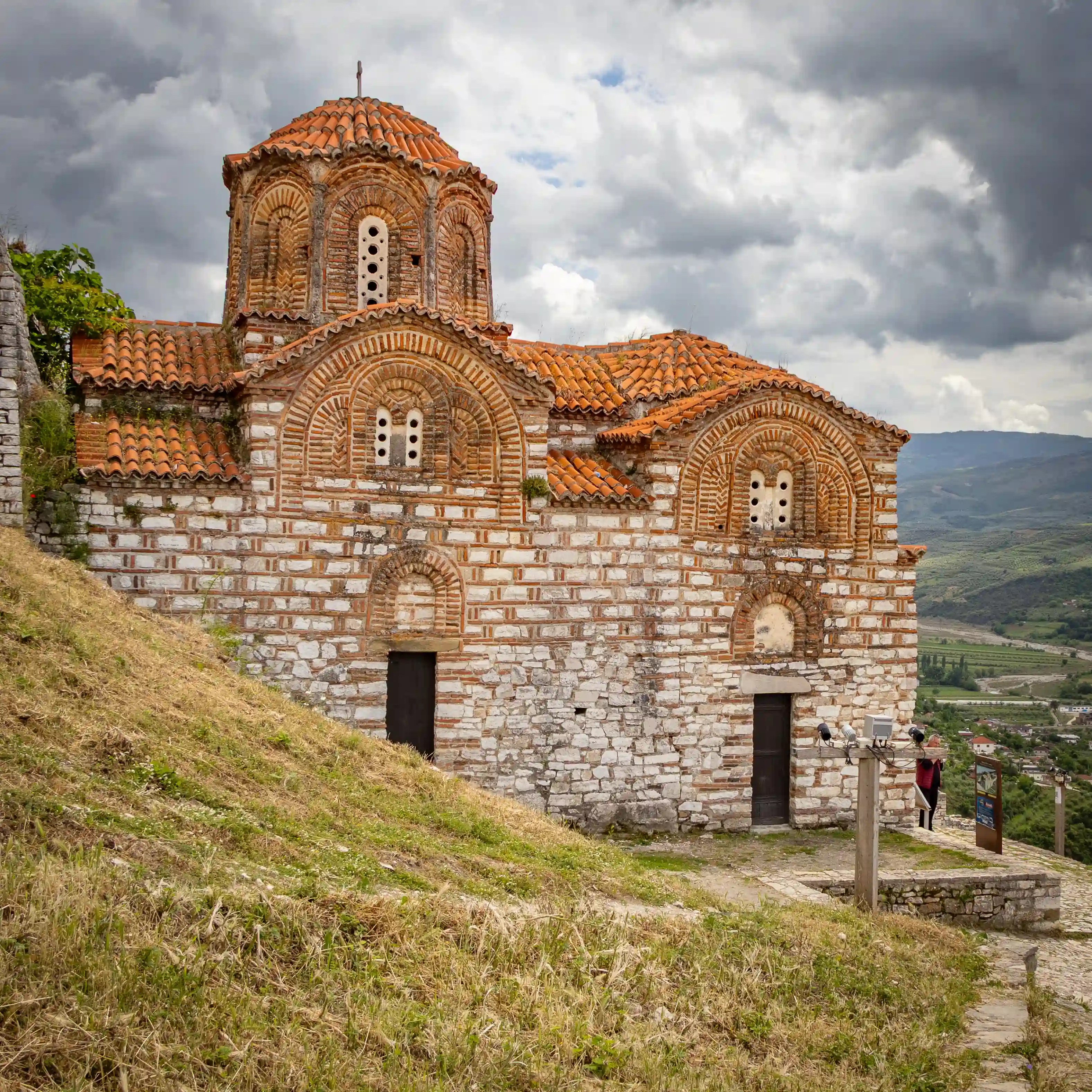 Side view of the Holy Trinity Church with mountains in the background.